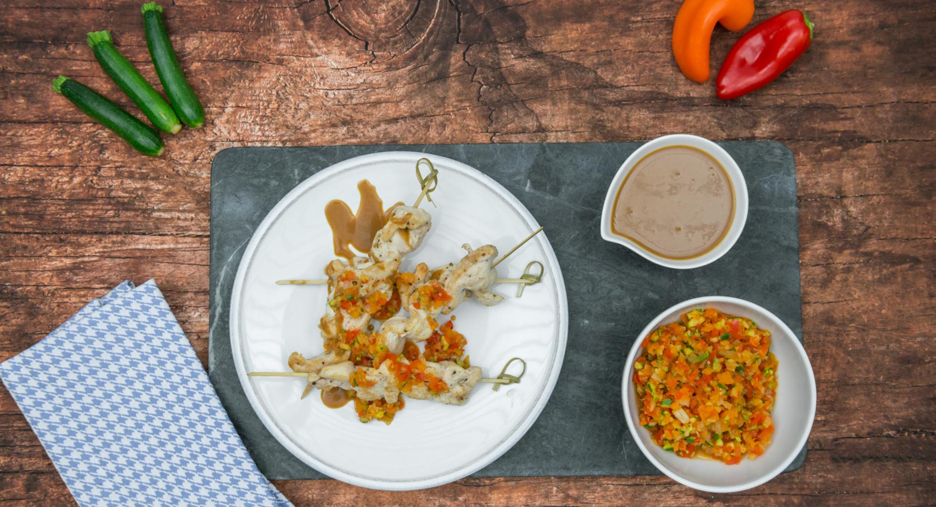 Colorful chicken skewers with peanut sauce