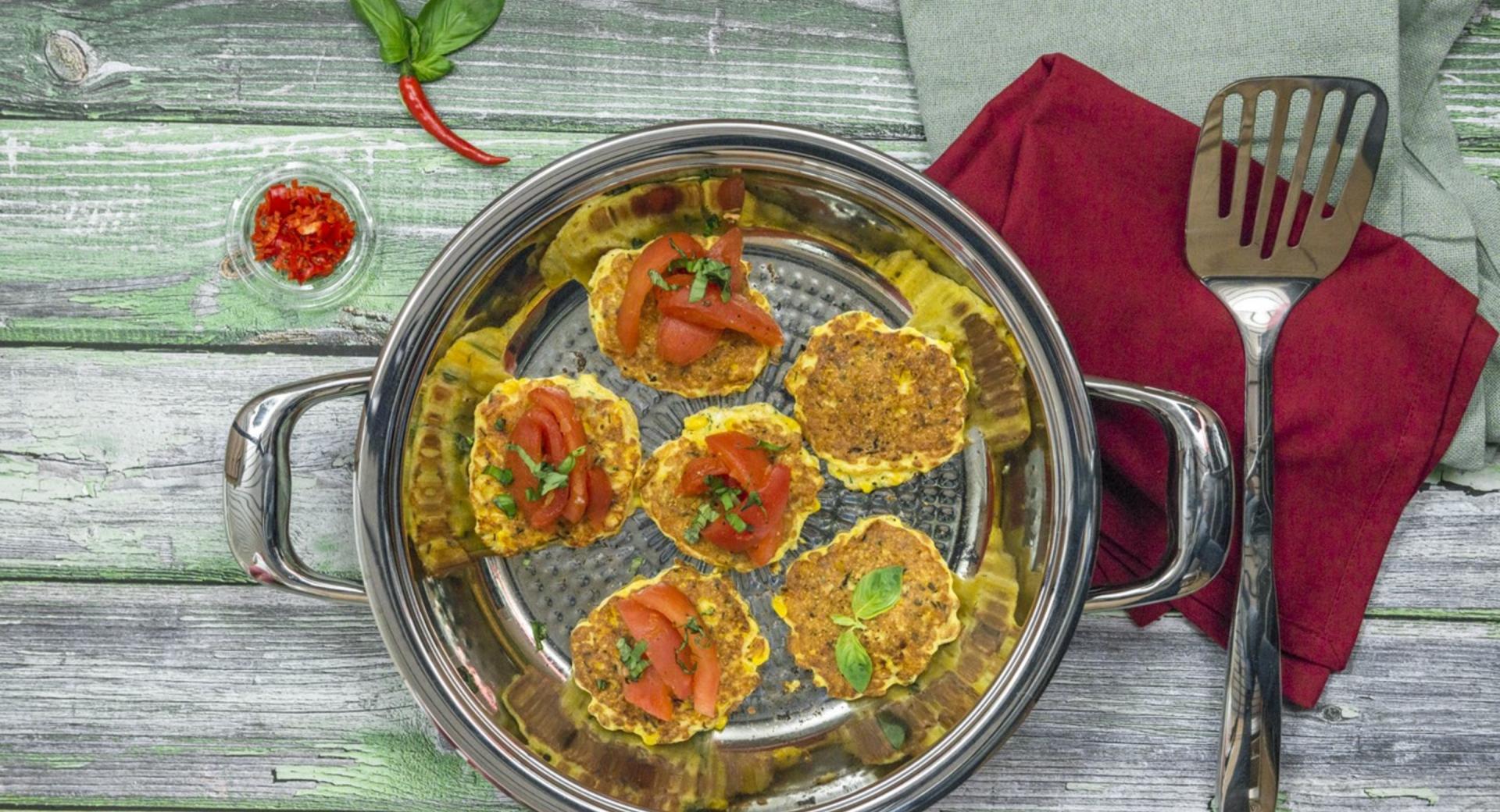 Corn patties with tomatoes 