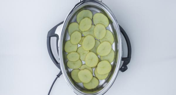 Place a layer of potatoes on base of the Oval Griddle and a layer of onion on top.