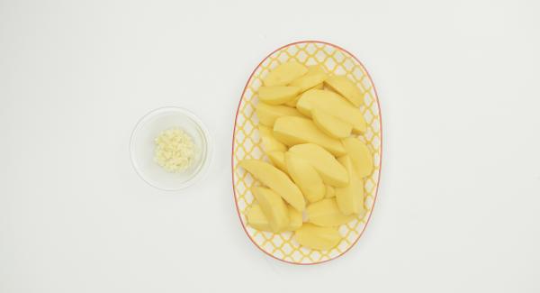 Wash potatoes thoroughly and cut into slices. Peel the garlic and chop finely.