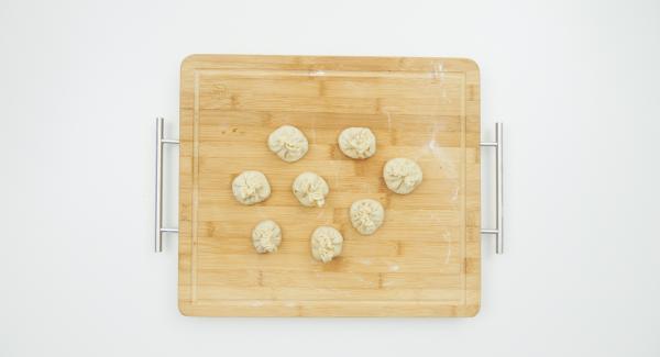 Knead the dough again and roll out thinly on a floured work surface in circles of approx. 10 cm in diameter. Season the filling with salt and add a small amount to the middle of each circle.