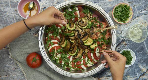 Before serving, pluck the basil leaves, chop finely and sprinkle over the tomatoes and mozzarella.