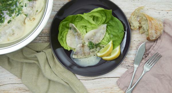 Pour the fish into the hot sauce, set at low level and leave to stand for approx. 5 minutes with the lid on, depending on the size of the fillets. Finely chop the herb leaves, add, season and serve.