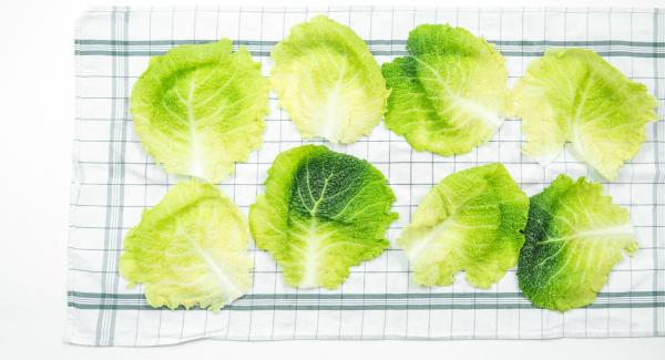 Drain the savoy cabbage leaves on a clean dishcloth, cut flat the hard ridges in the middle and place filling on it.