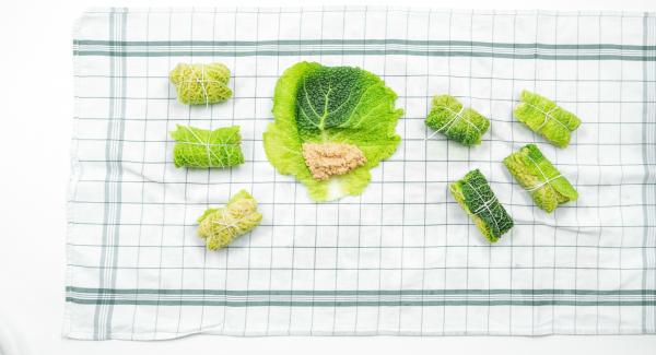 Drain the savoy cabbage leaves on a clean dishcloth, cut flat the hard ridges in the middle and place filling on it.