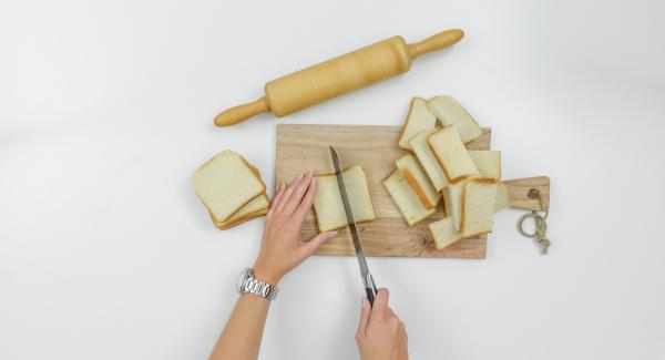 Halve bread slices. Roll flat with a rolling pin.