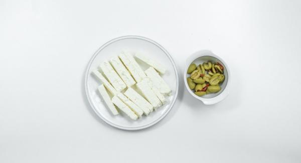 Cut sheep milk cheese into broad strips and halve the olives. Peel onions, halve and cut into thin slices. Pluck oregano leaves.