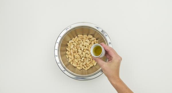 Mix cashew nuts and almonds with oil.