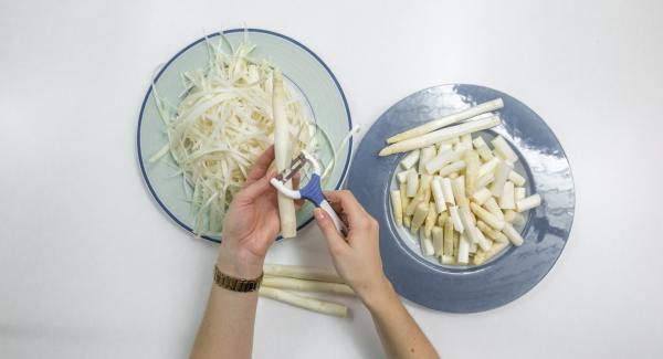 Peel asparagus and cut in bite-size pieces. Place dripping wet in a pot.