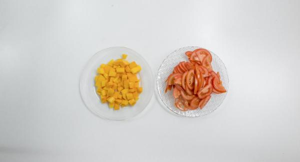 Clean the tomatoes and cut them in half depending on the size and slice them. Clean mango, remove the stone and cut into cubes.