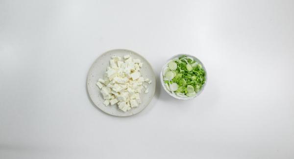 Clean the spring onions, cut into fine rings and dice the feta cheese.