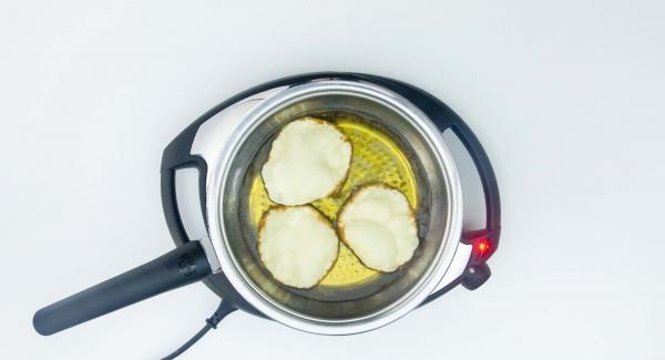 Turn the circles around and deep-fry on the other side. Prevent burning.