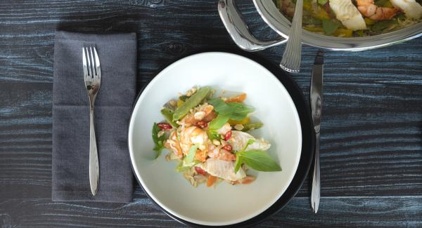 Sprinkle the platter with strips of Thai basil, chopped chilli and coarsely chopped peanuts as desired and serve at the table in the griddle.