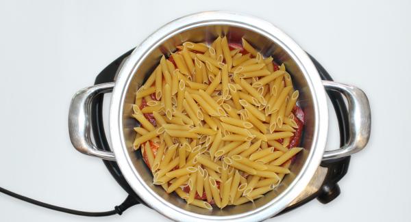 Add the pasta, then pour the vegetable stock.