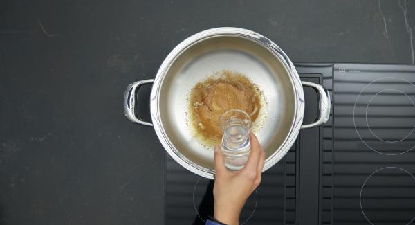 Remove from hob, carefully add the water and simmer until the caramel has dissolved.