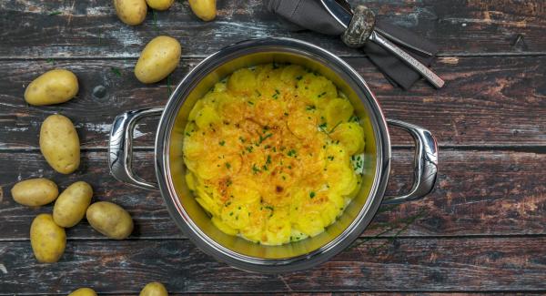 Spread cheese over the potatoes. Place pot in an inverted lid, place Navigenio overhead and set at high level. While the Navigenio flashes red/blue, enter approx. 10 minutes in the Audiotherm and gratinate until golden brown.