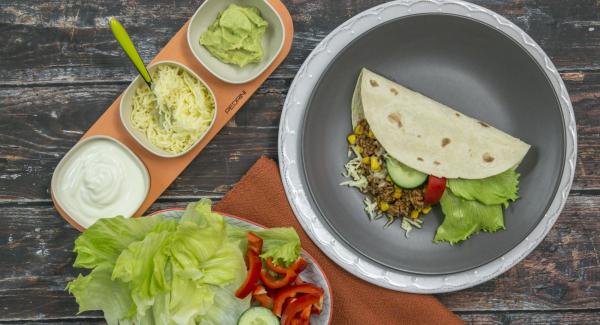 At the end of the cooking time take out tortillas, refine mince sauce with olive oil and season with salt and pepper. Fill tortillas with the filling and the other ingredients for serving.