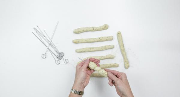 Wrap the dough in a spiral around the skewers, press the ends well. Cover and leave to rest for 5 minutes.