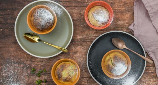 After baking, carefully remove the molds from the water bath, place them on a plate and serve immediately dusted with powdered sugar.