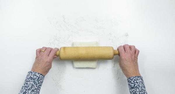 Roll out the puff pastry on a floured work surface and cut into twelve squares of 10 x 10 cm.
