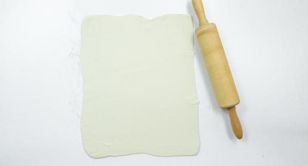 Roll out the puff pastry on a floured work surface and cut into twelve squares of 10 x 10 cm.