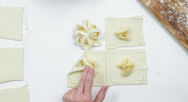 Place a few pear cubes in the middle and fold the edges of the dough over the pears like a flower and press down a little (see photo).