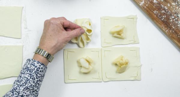 Place a few pear cubes in the middle and fold the edges of the dough over the pears like a flower and press down a little (see photo).