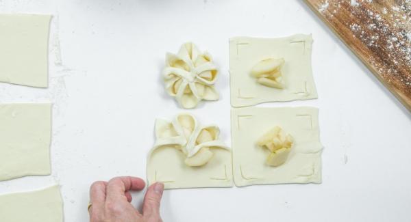 Place a few pear cubes in the middle and fold the edges of the dough over the pears like a flower and press down a little (see photo).