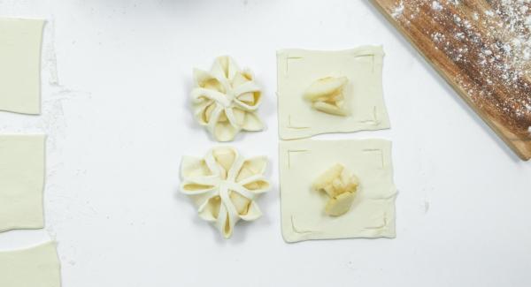 Place a few pear cubes in the middle and fold the edges of the dough over the pears like a flower and press down a little (see photo).