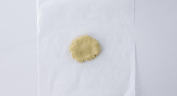 Place the dough between two sheets of baking paper.